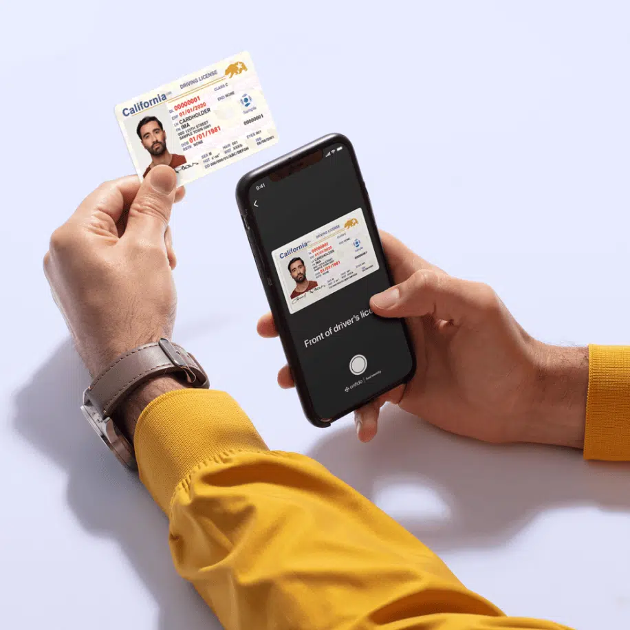 Person holding ID and phone