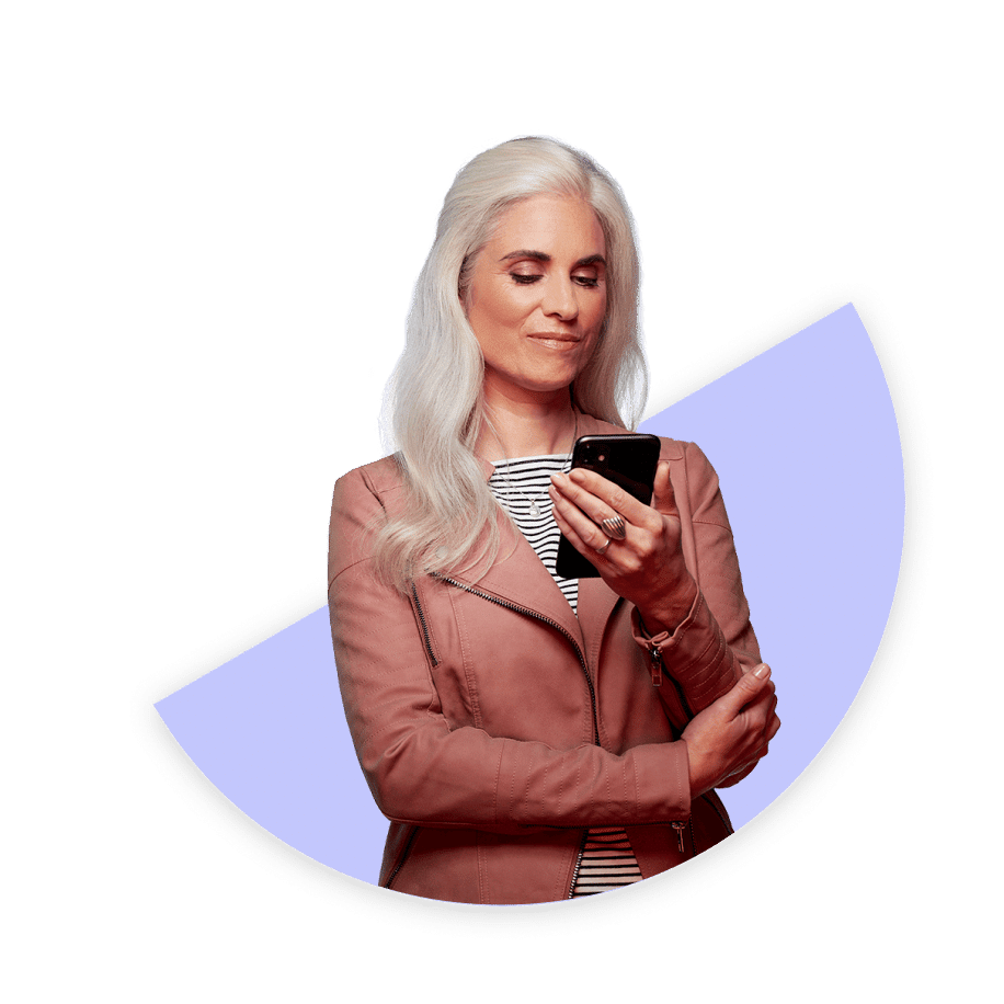 woman smirking looking at a phone