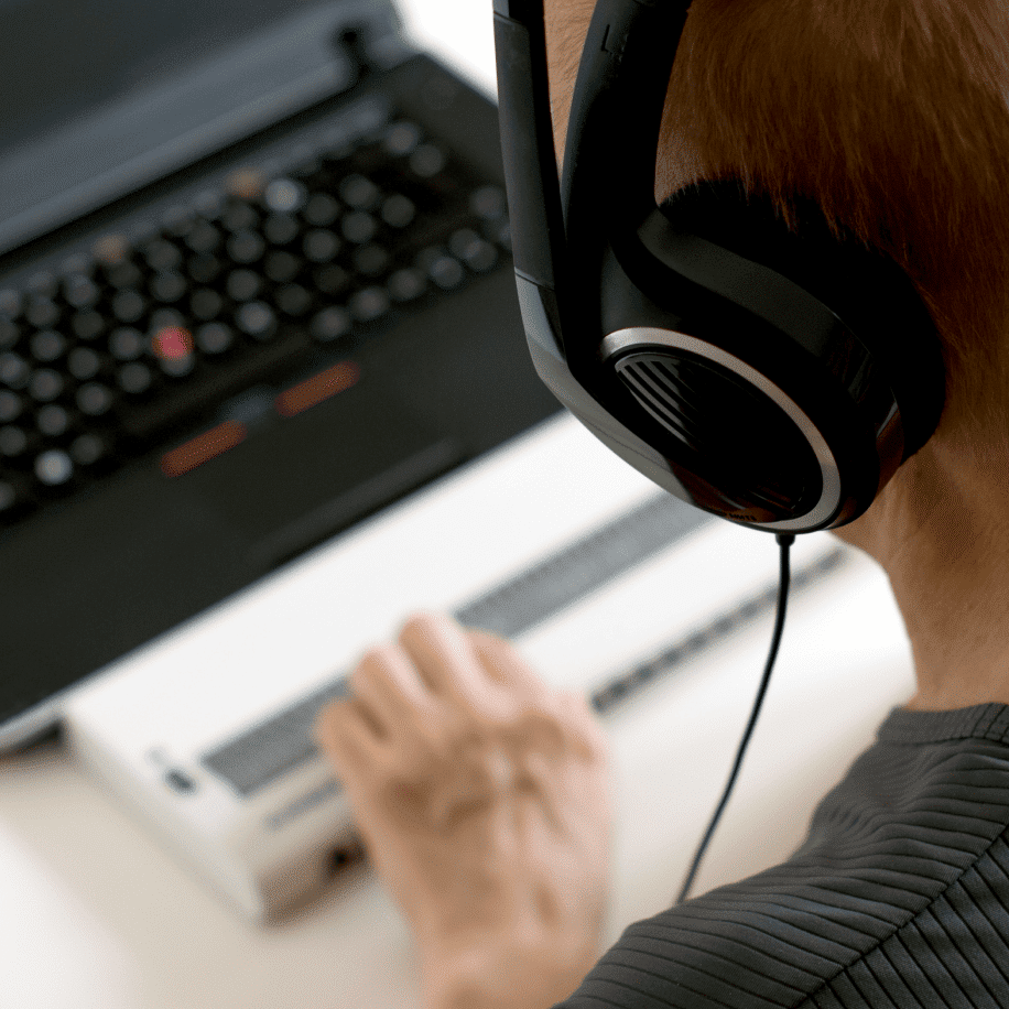 man on computer with headset